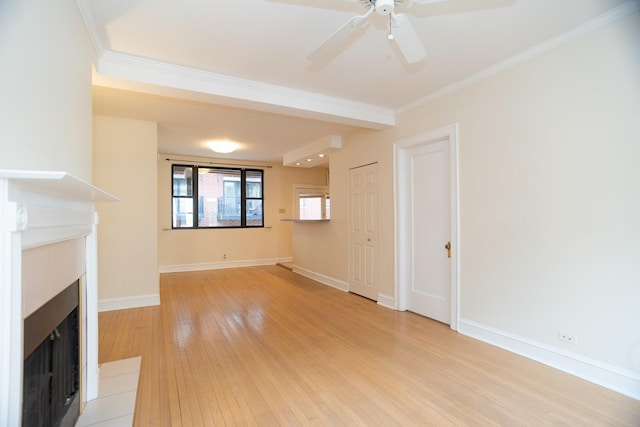 7631 N Eastlake Ter Unit 2C, Chicago, IL 60626 - unfurnished living room with a fireplace, light wood-style floors, crown molding, a ceiling fan, and baseboards