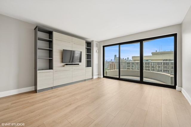 2020 N Lincoln Park W Unit 30L, Chicago, IL 60614 - unfurnished living room featuring light wood finished floors, baseboards, and built in shelves