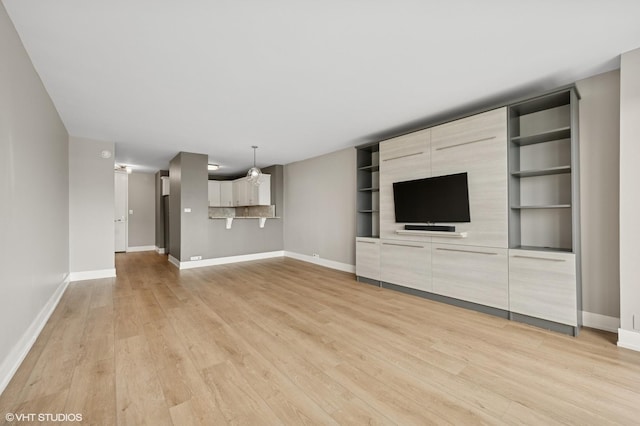 2020 N Lincoln Park W Unit 30L, Chicago, IL 60614 - unfurnished living room featuring baseboards and light wood-style floors
