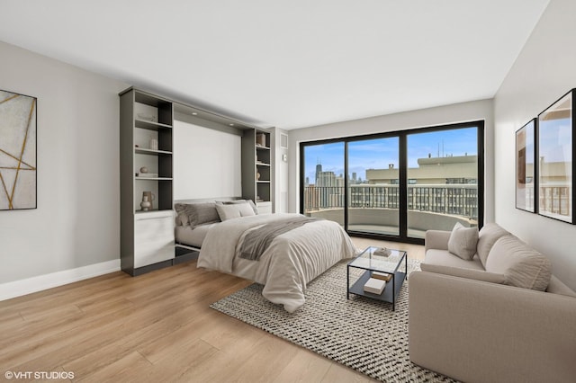 2020 N Lincoln Park W Unit 30L, Chicago, IL 60614 - bedroom featuring access to outside, light wood-style flooring, and baseboards