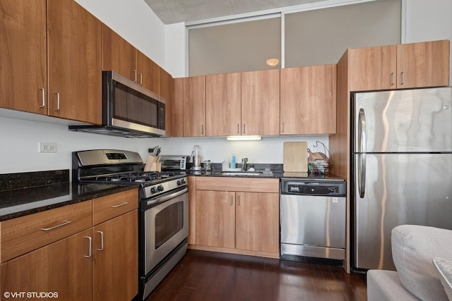 235 W Van Buren St Unit 3419, Chicago, IL 60607 - kitchen with stainless steel appliances, dark stone counters, dark wood-type flooring, and brown cabinetry