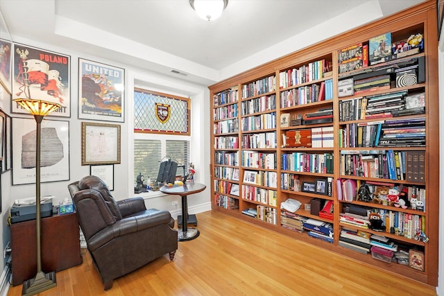 1705 N Crilly Ct Unit 2, Chicago, IL 60614 - sitting room with wood finished floors, bookshelves, and a tray ceiling