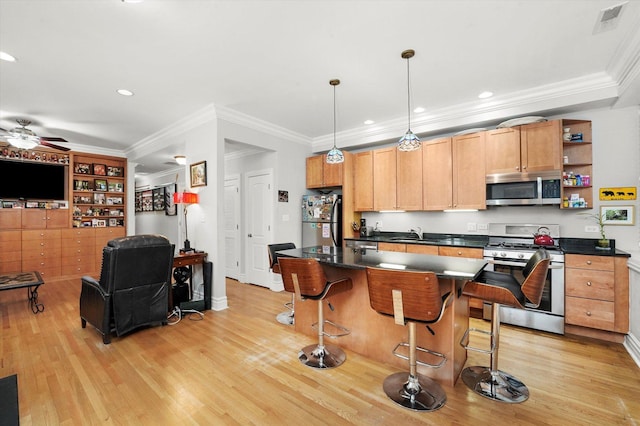 1705 N Crilly Ct Unit 2, Chicago, IL 60614 - kitchen featuring stainless steel appliances, dark countertops, light wood-style flooring, a ceiling fan, and ornamental molding