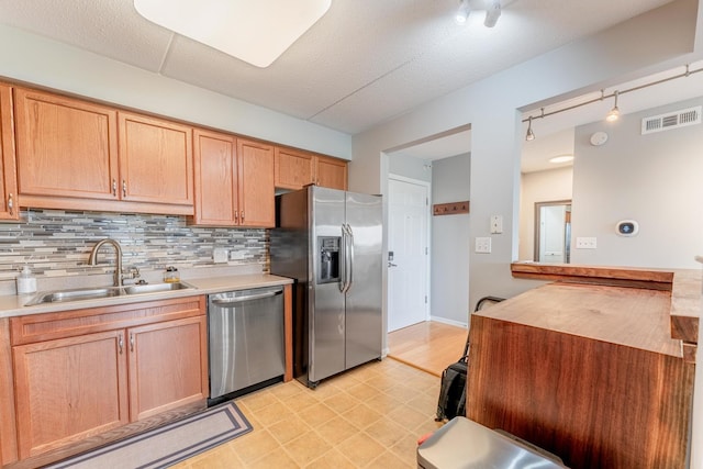 390 S Western Ave Unit 504, Des Plaines, IL 60016 - kitchen with stainless steel appliances, rail lighting, tasteful backsplash, and light countertops