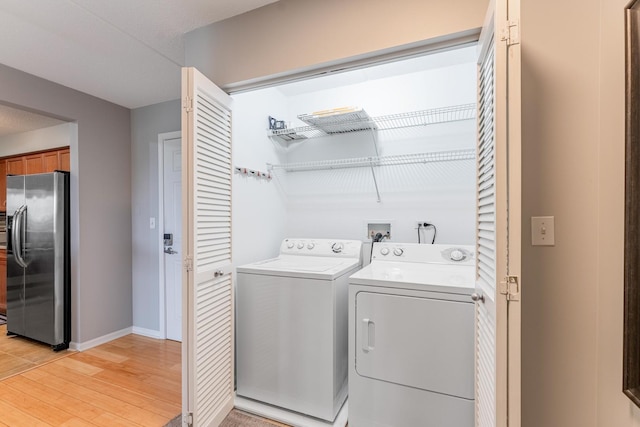 390 S Western Ave Unit 504, Des Plaines, IL 60016 - laundry room with washing machine and dryer and light wood-style floors