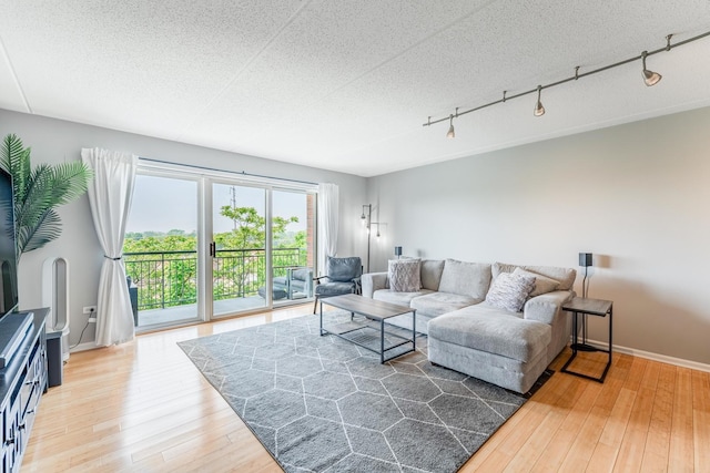 390 S Western Ave Unit 504, Des Plaines, IL 60016 - living area featuring light wood-style floors, rail lighting, and a textured ceiling
