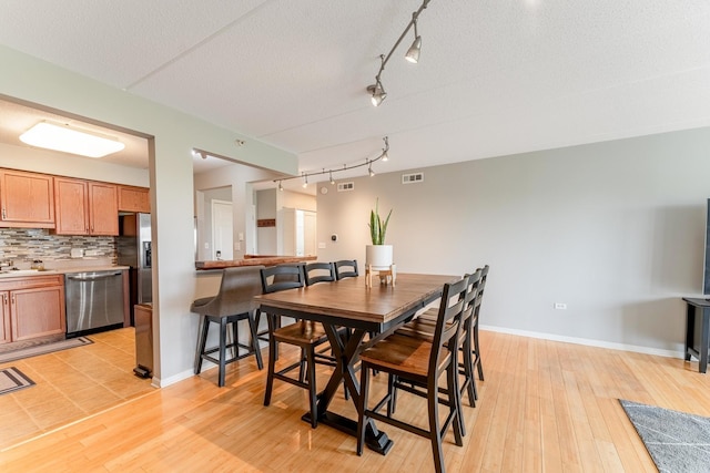 390 S Western Ave Unit 504, Des Plaines, IL 60016 - dining area featuring track lighting and light wood-style flooring