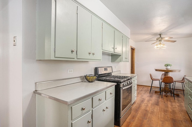 2258 177th St, Lansing, IL 60438 - kitchen with stainless steel gas range, ceiling fan, wood finished floors, and light countertops
