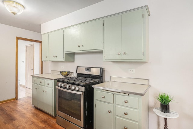2258 177th St, Lansing, IL 60438 - kitchen featuring stainless steel range with gas stovetop, light countertops, wood finished floors, and baseboards