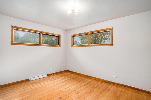 2258 177th St, Lansing, IL 60438 - empty room featuring baseboard heating, baseboards, and light wood-type flooring