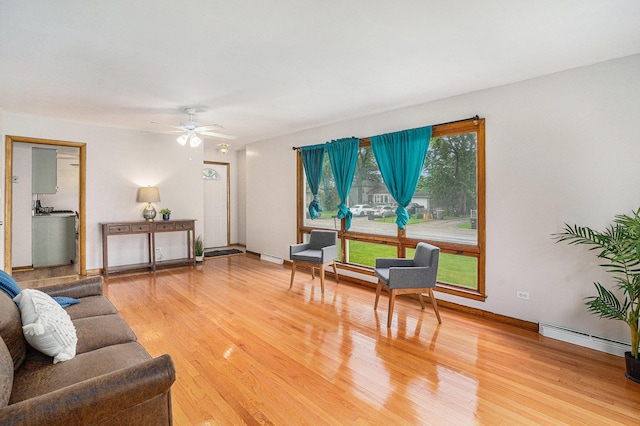 2258 177th St, Lansing, IL 60438 - living area with light wood-style flooring, a baseboard radiator, a ceiling fan, and baseboards