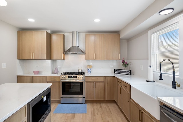 791 N Michigan St, Elmhurst, IL 60126 - kitchen with wall chimney range hood, appliances with stainless steel finishes, a sink, light brown cabinets, and light wood-style floors