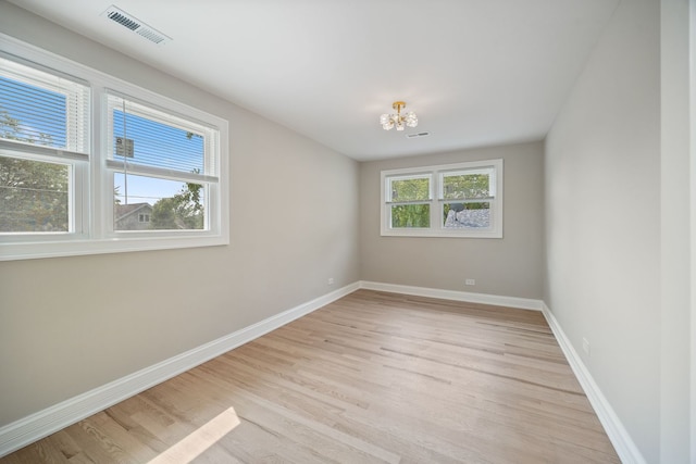 791 N Michigan St, Elmhurst, IL 60126 - spare room featuring a chandelier, light wood-type flooring, and baseboards