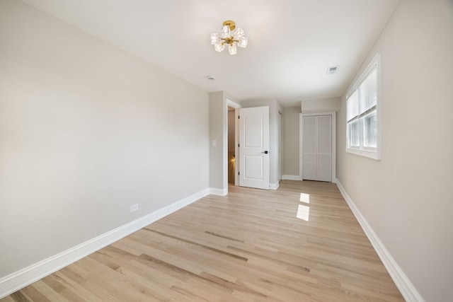 791 N Michigan St, Elmhurst, IL 60126 - empty room featuring a chandelier, light wood finished floors, and baseboards