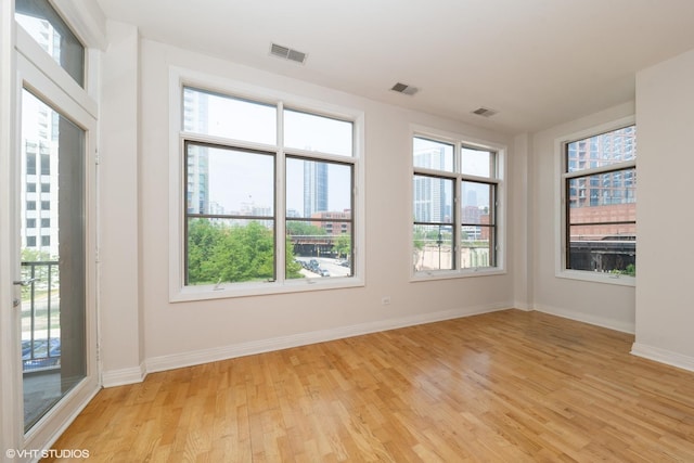 330 N Clinton St Unit 303, Chicago, IL 60661 - unfurnished room featuring light wood-style flooring, baseboards, and a view of city