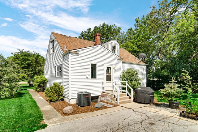 20801 Western Ave, Chicago Heights, IL 60411 - back of property featuring a shingled roof, a chimney, and a patio area