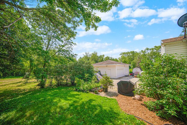 20801 Western Ave, Chicago Heights, IL 60411 - view of green lawn featuring an outdoor structure, a garage, and driveway