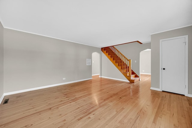 20801 Western Ave, Chicago Heights, IL 60411 - unfurnished living room featuring arched walkways, ornamental molding, stairway, and light wood-style floors