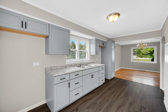 20801 Western Ave, Chicago Heights, IL 60411 - kitchen with light countertops, a chandelier, dark wood-style floors, crown molding, and gray cabinetry