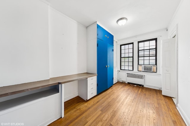 6901 S Oglesby Ave Unit 2A, Chicago, IL 60649 - unfurnished office featuring radiator heating unit, light wood-style flooring, ornamental molding, built in desk, and cooling unit