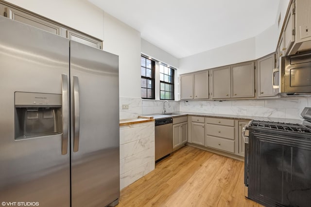 6901 S Oglesby Ave Unit 2A, Chicago, IL 60649 - kitchen with appliances with stainless steel finishes, light wood finished floors, a sink, backsplash, and wooden counters