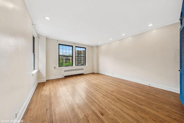 6901 S Oglesby Ave Unit 2A, Chicago, IL 60649 - spare room featuring radiator heating unit, light wood finished floors, baseboards, and recessed lighting