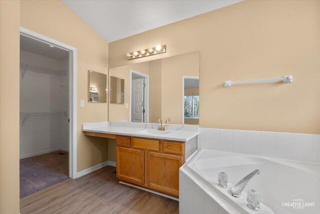 2539 Lexington Ln, Naperville, IL 60540 - full bath with wood finished floors, vanity, a garden tub, vaulted ceiling, and a spacious closet