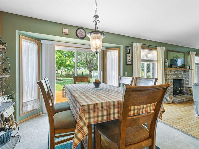 4306 Westridge Dr, Winnebago, IL 61088 - dining room with light tile patterned floors and a brick fireplace