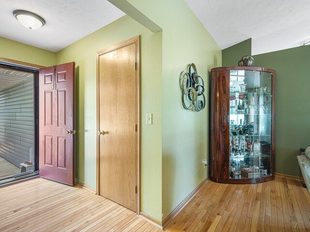 4306 Westridge Dr, Winnebago, IL 61088 - entrance foyer featuring wood-type flooring, a textured ceiling, and baseboards