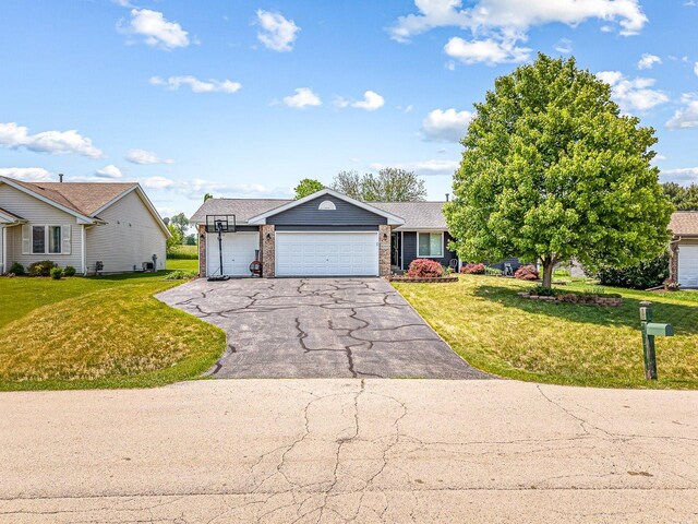 4306 Westridge Dr, Winnebago, IL 61088 - view of front facade featuring an attached garage, a front yard, and asphalt driveway