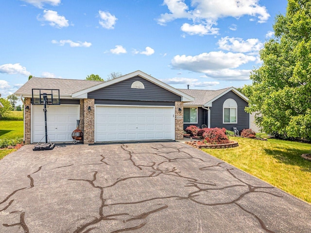 4306 Westridge Dr, Winnebago, IL 61088 - ranch-style house featuring asphalt driveway, brick siding, a front yard, a garage, and roof with shingles