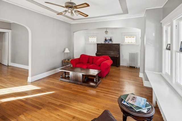212 S Austin Blvd, Oak Park, IL 60304 - living room featuring radiator, arched walkways, a ceiling fan, hardwood / wood-style flooring, and ornamental molding
