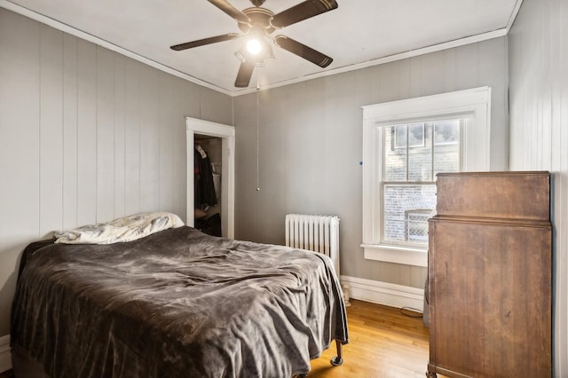 212 S Austin Blvd, Oak Park, IL 60304 - bedroom with radiator, crown molding, light wood-style floors, and ceiling fan
