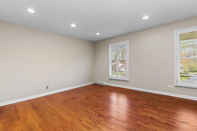 43 Kings Cross Dr, Lincolnshire, IL 60069 - unfurnished room featuring baseboards, healthy amount of natural light, wood finished floors, and recessed lighting