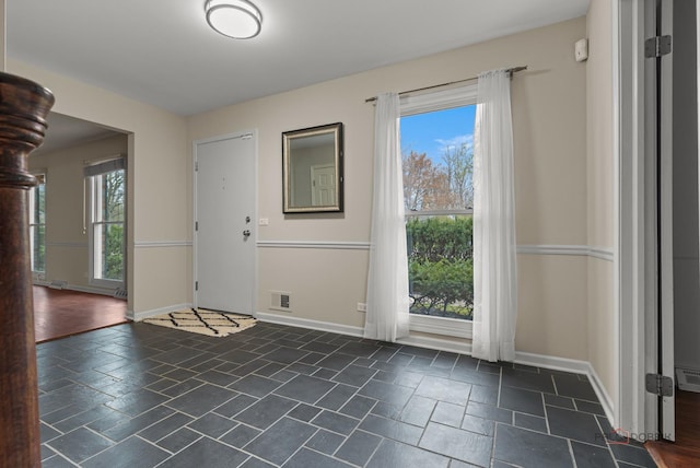 43 Kings Cross Dr, Lincolnshire, IL 60069 - entrance foyer with baseboards and stone tile flooring