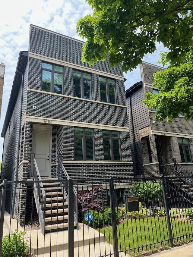 6336 S Kimbark Ave, Chicago, IL 60637 - view of front facade with brick siding, a fenced front yard, and a gate