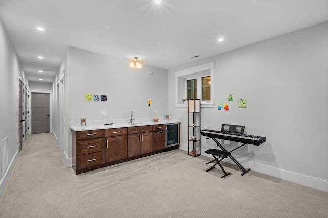 6336 S Kimbark Ave, Chicago, IL 60637 - kitchen with light carpet, light countertops, recessed lighting, wine cooler, and dark brown cabinets