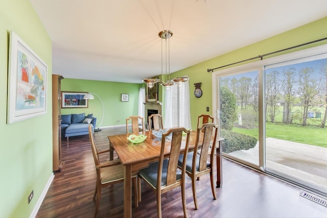 1226 Beau Dr, Park Ridge, IL 60068 - dining space featuring dark wood-type flooring, baseboards, and a large fireplace