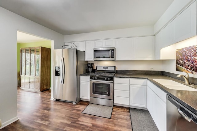 1226 Beau Dr, Park Ridge, IL 60068 - kitchen with stainless steel appliances, a sink, dark countertops, and dark wood-style floors