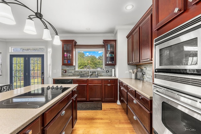 24147 S Sunset Dr, Channahon, IL 60410 - kitchen featuring stainless steel appliances, light wood-style flooring, healthy amount of natural light, backsplash, and ornamental molding