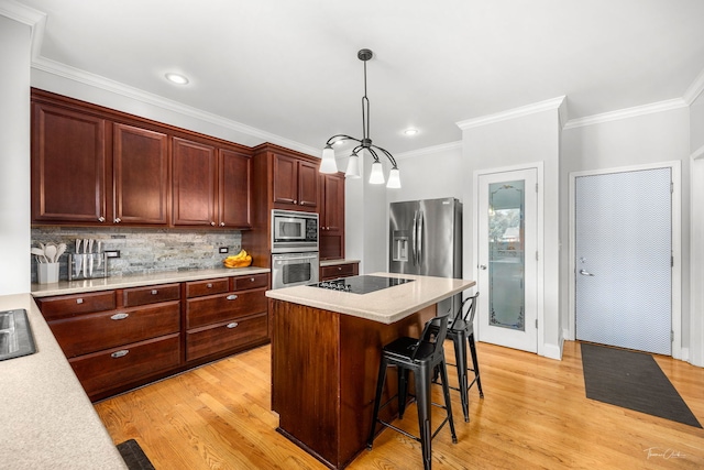 24147 S Sunset Dr, Channahon, IL 60410 - kitchen featuring stainless steel appliances, ornamental molding, light countertops, a kitchen bar, and light wood-style floors