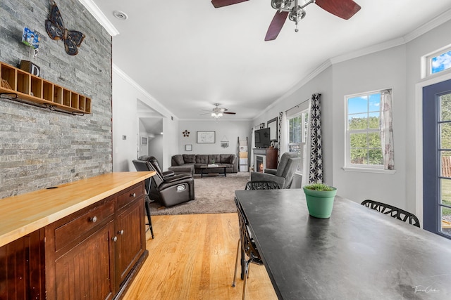 24147 S Sunset Dr, Channahon, IL 60410 - dining area featuring a ceiling fan, crown molding, and light wood-style floors