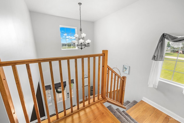 24147 S Sunset Dr, Channahon, IL 60410 - stairway with a chandelier, healthy amount of natural light, and wood finished floors