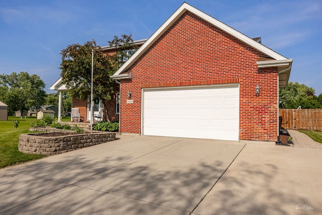 24147 S Sunset Dr, Channahon, IL 60410 - view of side of property featuring driveway, brick siding, and a garage