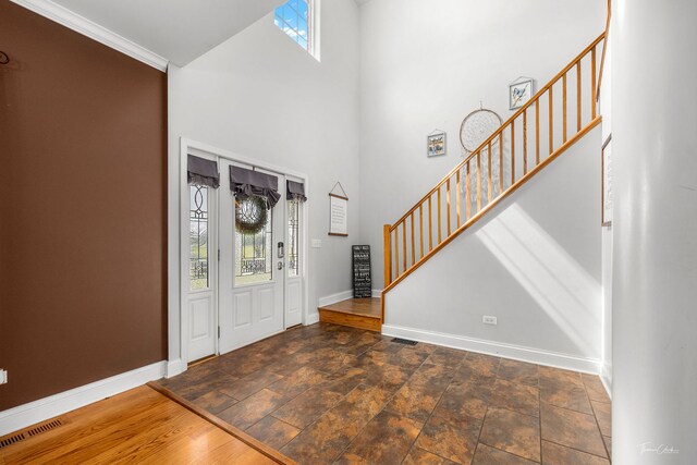 24147 S Sunset Dr, Channahon, IL 60410 - entryway featuring stairs, a high ceiling, and stone finish flooring