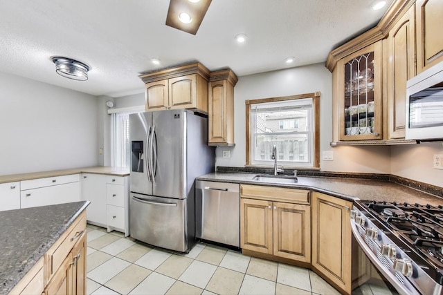 1564 Webster Ln, Des Plaines, IL 60018 - kitchen featuring stainless steel appliances, a sink, glass insert cabinets, dark stone countertops, and recessed lighting