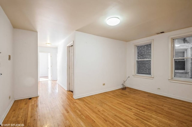 238 W 31st St Unit 2W, Chicago, IL 60616 - spare room featuring light wood-type flooring and baseboards