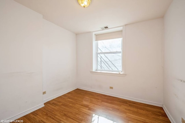 238 W 31st St Unit 2W, Chicago, IL 60616 - unfurnished room with wood finished floors and baseboards