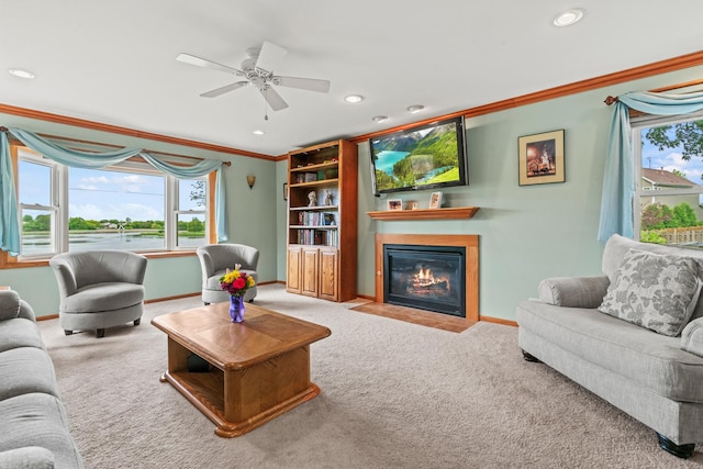 7 Farmington Ct, Lake In The Hills, IL 60156 - carpeted living room featuring ornamental molding, a fireplace with flush hearth, recessed lighting, baseboards, and ceiling fan