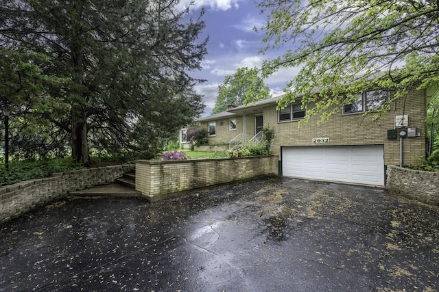 2632 E Bonnie Brook Ln, Waukegan, IL 60087 - view of front of home with driveway, a garage, and brick siding